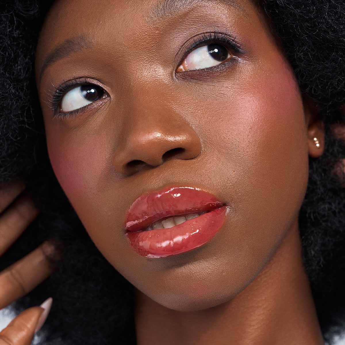 Pink Flare glossy pink lip look on a deep skin tone